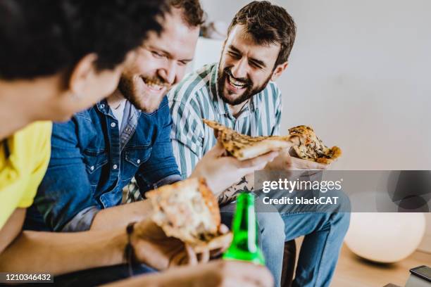 male friends having fun - man cave stock pictures, royalty-free photos & images