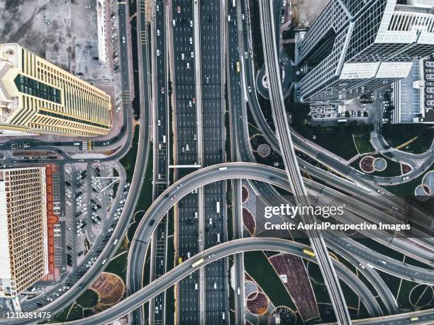 drone point view of dubai road intersection - drone picture architekture stock-fotos und bilder