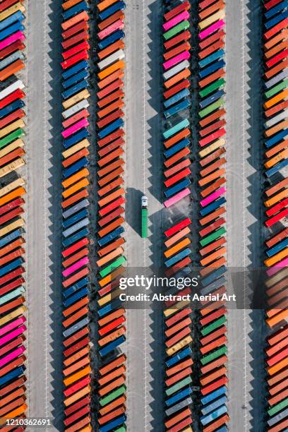 aerial shot of a truck picking up a cargo crate in a container yard, georgia, united states of america - art product photos et images de collection