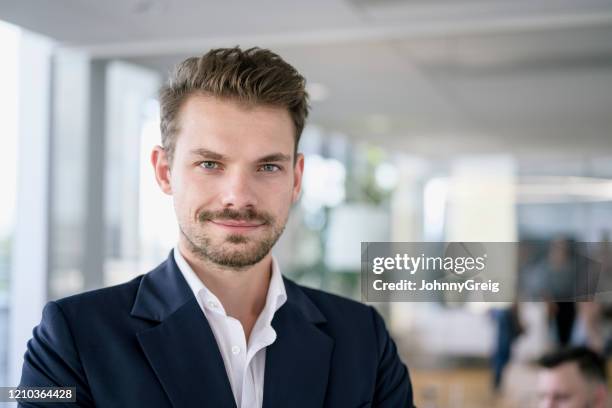 working portrait of confident mid adult businessman - blue blazer stock pictures, royalty-free photos & images