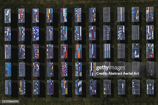 solar panels with unusual patterns photographed by drone, florida, united states of america - drone picture architekture stock-fotos und bilder