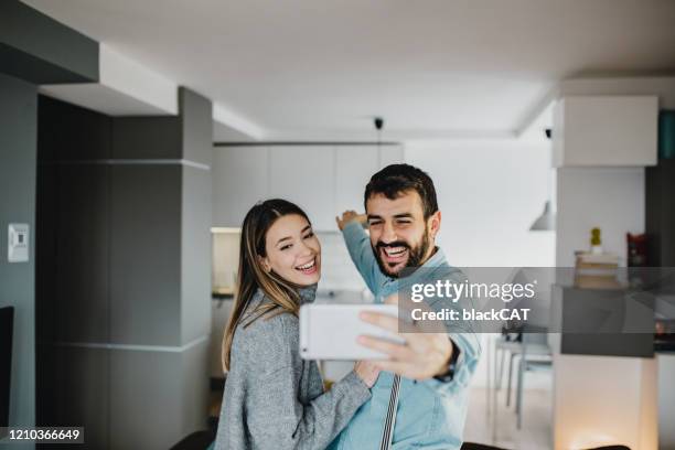 couple in their new home - celebrates firsts imagens e fotografias de stock