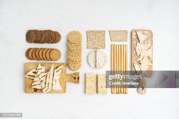 assorted healthy snacks in knolling style - crackers stock-fotos und bilder