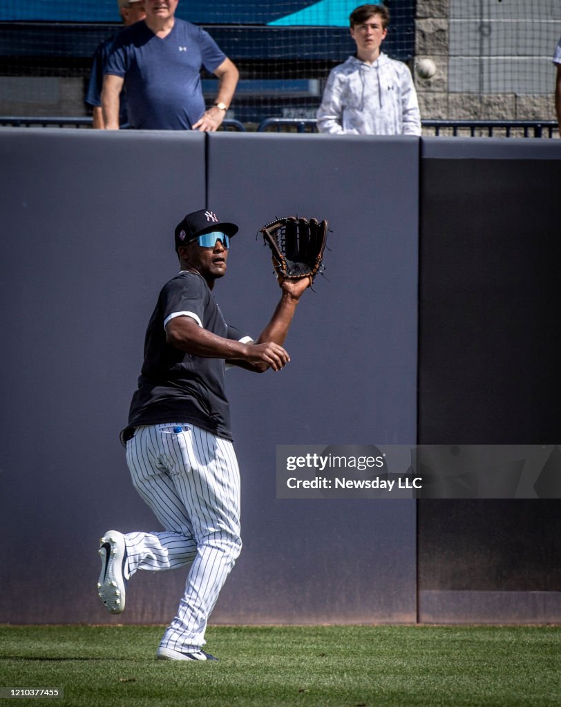 New York Yankees' infielder Miguel Andujar fields fly balls in left