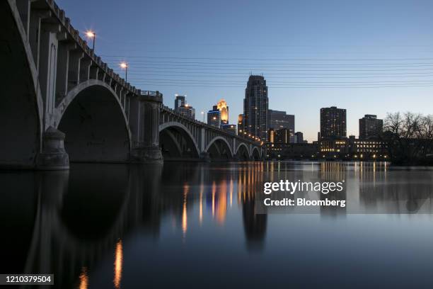 Building stand illuminated at dusk in downtown Minneapolis, Minnesota, U.S., on Saturday, April 18, 2020. Governor Tim Walz of Minnesota, a state...