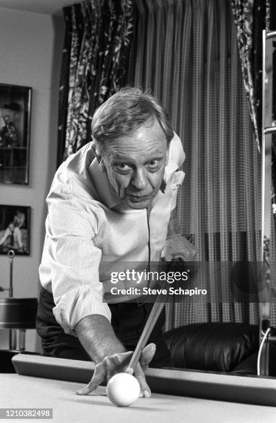 View of American comedian and actor Don Knotts as he plays pool, Los Angeles, California, 1980s or 1990s.