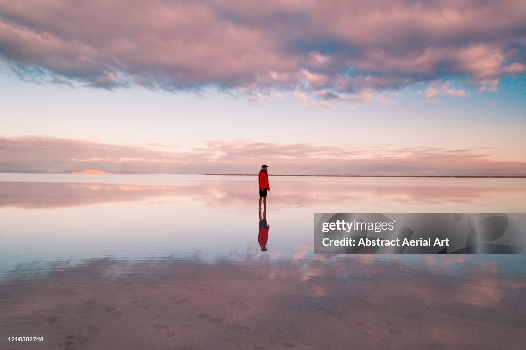 One person standing on the flooded Bonneville salt flats, Utah, United States of America