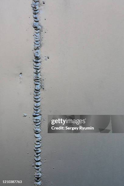 welding seam on painted sheet steel - seam stock pictures, royalty-free photos & images