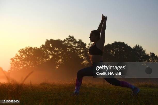 young girl doing exercises outdoors. - steppe stock pictures, royalty-free photos & images