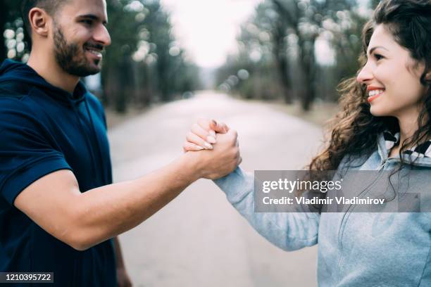 porty couple holding hands together - the united arab emirates stock pictures, royalty-free photos & images