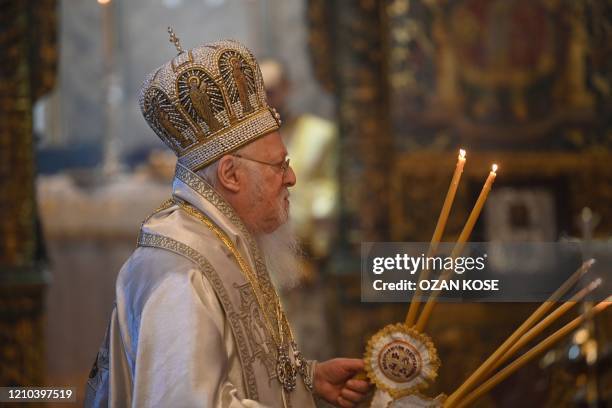 Ecumenical patriarch Bartholomew I , spiritual leader of Greek Orthodox world leads the Easter ceremony during curfew behind the closed doors...