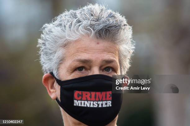 Woman wearing a face mask as she protests at a rally in Rabin Square on April 19, 2020 in Tel Aviv, Israel. Thousands of Israelis gather at an...