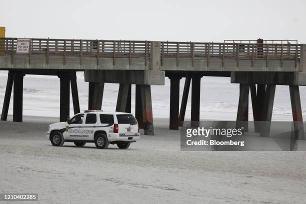 Police officers patrol the beach in Jacksonville Beach, Florida, U.S., on Saturday, April 18, 2020. Florida reported a total of 25,269 confirmed...