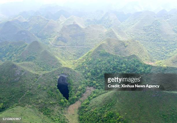 April 19, 2020 -- Aerial Photo taken on April 19, 2020 shows a Tiankeng, or giant karst sinkhole, at Leye-Fengshan Global Geopark, south China's...