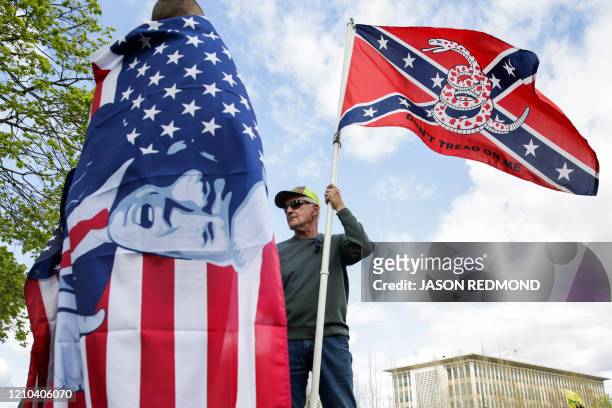 Keith Weber of Centralia, Washington holds a flag that combines a Gadsden flag from the American Revolution with a Confederate flag from the American...