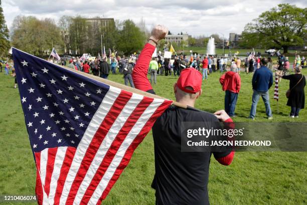 Matthew O'Neal of Snohomish, Washington, holds up his fist during a demonstration against Washington state's stay-home order at the state capitol in...