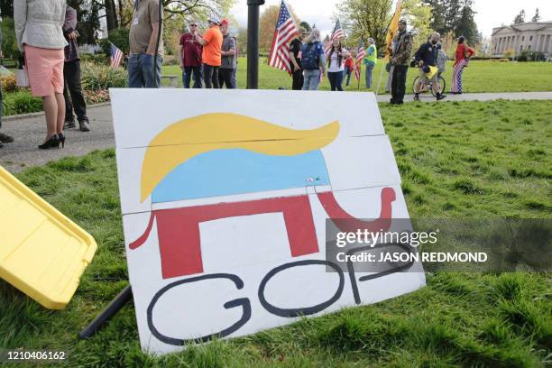 Republican Party elephant logo is pictured with the hair of US President Donald Trump during a demonstration against Washington state's stay-home...
