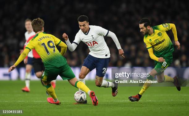 Dele Alli of Tottenham Hotspur battles for possession with Tom Trybull and Mario Vrancic of Norwich City during the FA Cup Fifth Round match between...