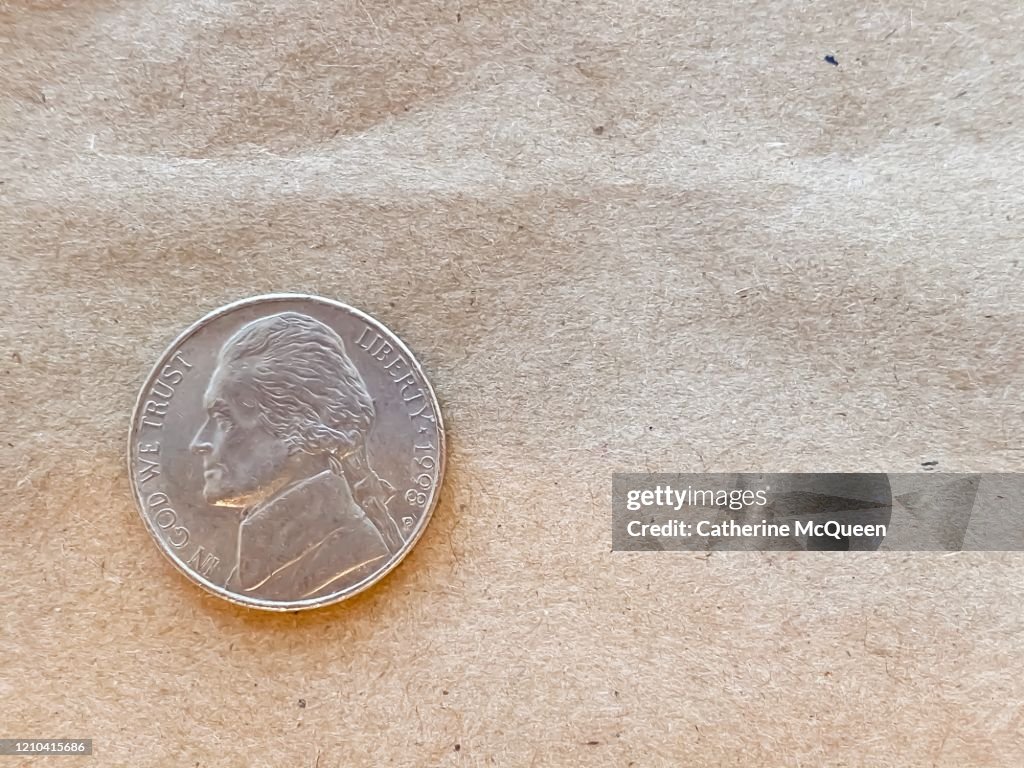 Brown paper bag background and u.s. nickel