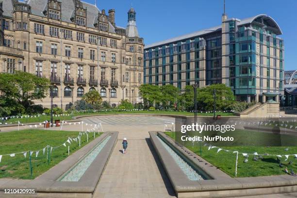 Child runs through a pathway in the Peace Gardens in Sheffield , on 19 April 2020.