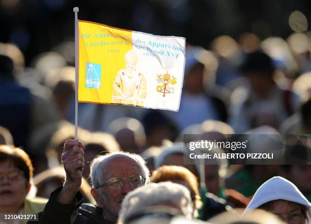 Faithful holds a Vatican flag on September 15, 2008 during a special mass for the sick celebrates by Pope Benedict XVI at the Basilica of the Rosary...