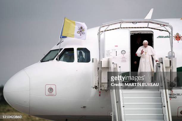 Pope Benedict XVI comes out of his plane upon his arrival at Orly airport, south of Paris, on September 12, 2008 for his first visit to France to...