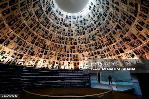 Picture taken on April 20 shows a security guard walking past the Hall of Names, bearing names and pictures of Jewish Holocaust victims, at the Yad...