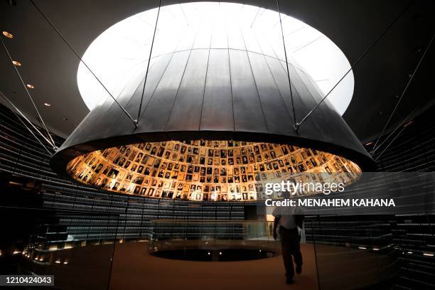 Picture taken on April 20 shows a an employee leaving the Hall of Names, bearing names and pictures of Jewish Holocaust victims, at the Yad Vashem...