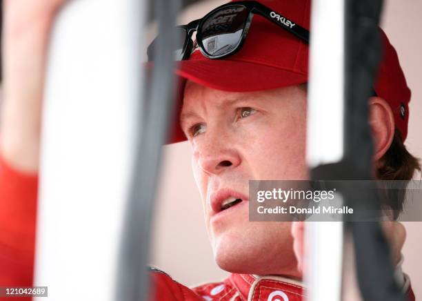 Scott Dixon of New Zealand, driver of the Target Chip Ganassi Dallara Honda, looks on from the pits during practice for the IZOD IndyCar Series...