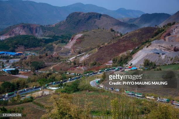 Food trucks wait to enter China near Muse, close to the Chinese border in Shan state, on April 20 after China reduced the number of food trucks...