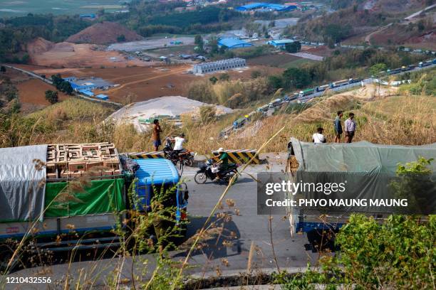 Food trucks wait to enter China near Muse, close to the Chinese border in Shan state, on April 20 after China reduced the number of food trucks...