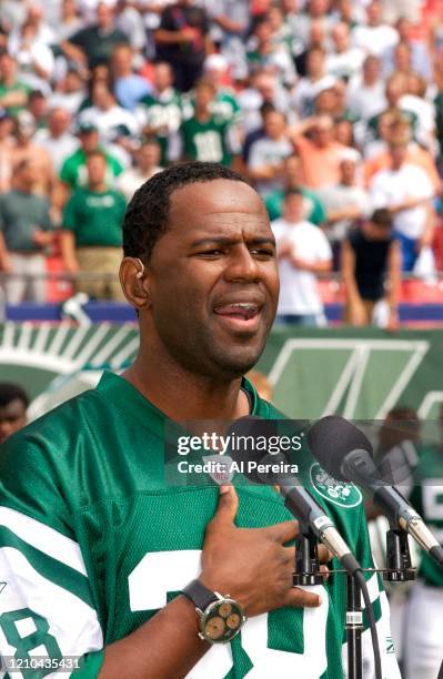 Musician Brian McKnight performs The National Anthem when he attends the New York Jets vs Miami Dolphins game at The Meadowlands on September 14,...