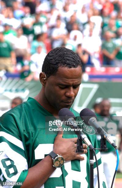 Musician Brian McKnight performs The National Anthem when he attends the New York Jets vs Miami Dolphins game at The Meadowlands on September 14,...