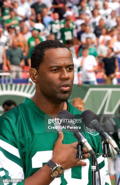 Musician Brian McKnight performs The National Anthem when he attends the New York Jets vs Miami Dolphins game at The Meadowlands on September 14,...