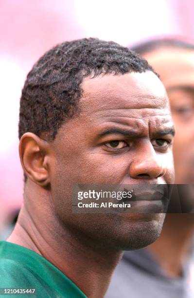 Musician Brian McKnight follows the action from the sideline when he performs The National Anthem when he attends the New York Jets vs Miami Dolphins...