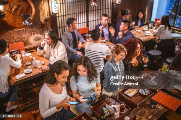 high angle view of male and female patrons at tokyo izakaya - izakaya imagens e fotografias de stock