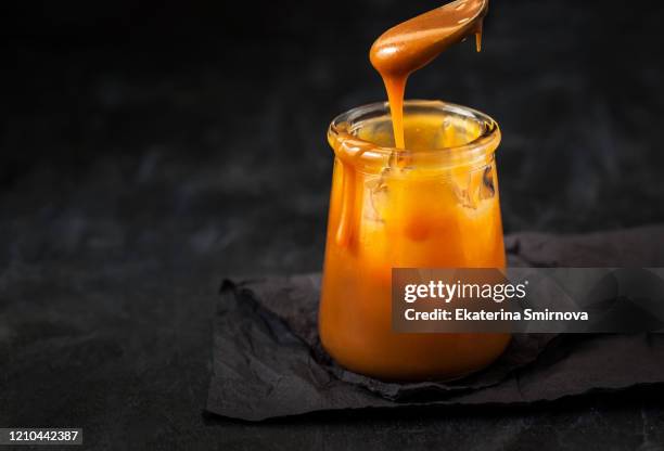 homemade salted caramel sauce in jar - caramel stock pictures, royalty-free photos & images