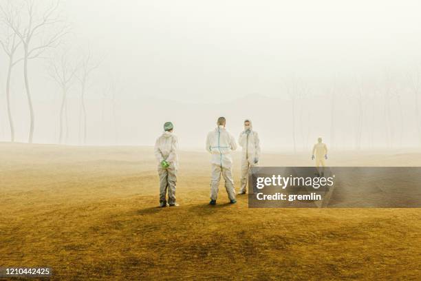 group of scientists in foggy desert - climate research stock pictures, royalty-free photos & images