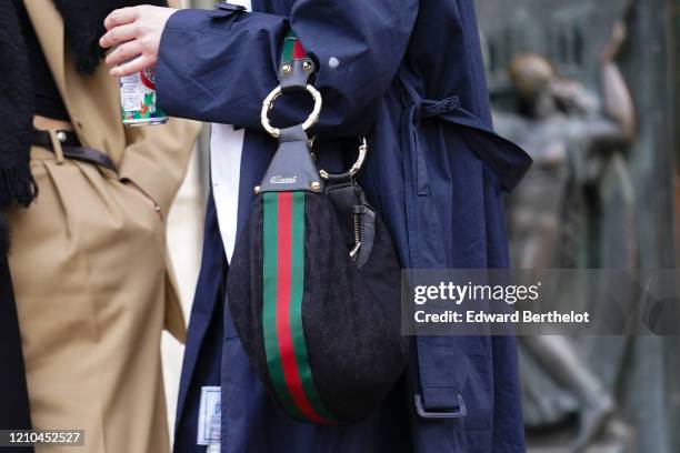 Guest wears a navy-blue trench coat, a Gucci bag, outside Akris, during Paris Fashion Week - Womenswear Fall/Winter 2020/2021, on March 02, 2020 in...