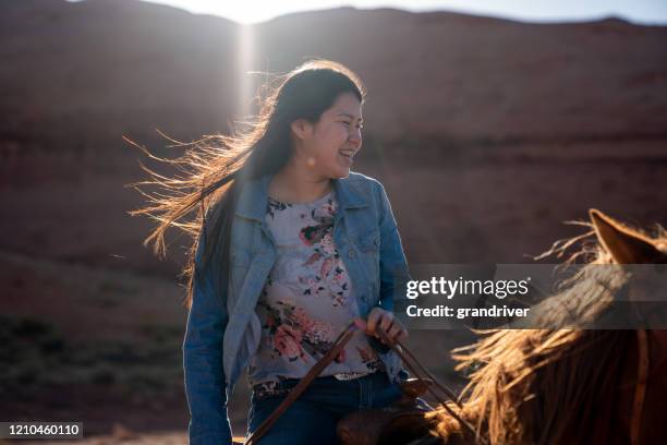 beautiful young teenage navajo native american girl on her horse in the northern arizona monument valley area - apache ethnicity stock pictures, royalty-free photos & images