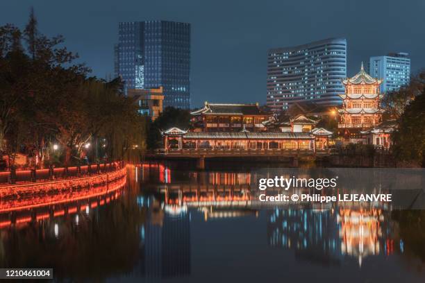 baihuatan chinese traditional bridge and pagoda illuminated at night and reflecting in the jinjiang river in chengdu - chinese festival stock pictures, royalty-free photos & images