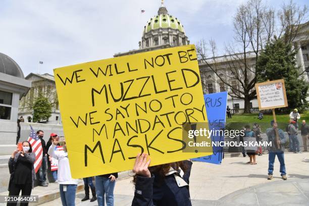 People take part in a "reopen" Pennsylvania demonstration on April 20, 2020 in Harrisburg, Pennsylvania. - Hundreds have protested in cities across...