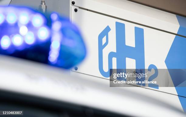 April 2020, Lower Saxony, Osnabrück: The blue light of a patrol car of the brand Hyundai, model "Nexo" can be seen at a filling station for hydrogen....