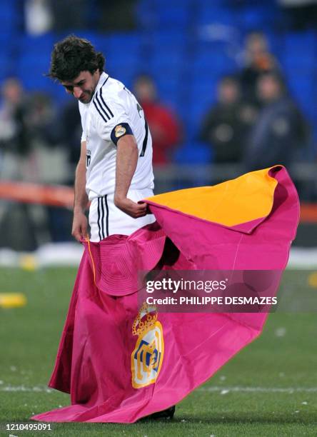 Real Madrid's captain Raul Gonzalez poses with a matador's cape as he celebrates winning the Spanish league title at the Santiago Bernabeu stadium in...