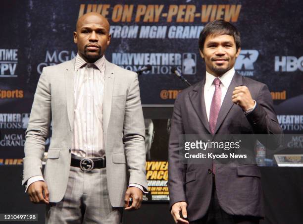 Floyd Mayweather of the United States and Manny Pacquiao of the Philippines pose for a photo in Los Angeles on March 11 during a press conference to...