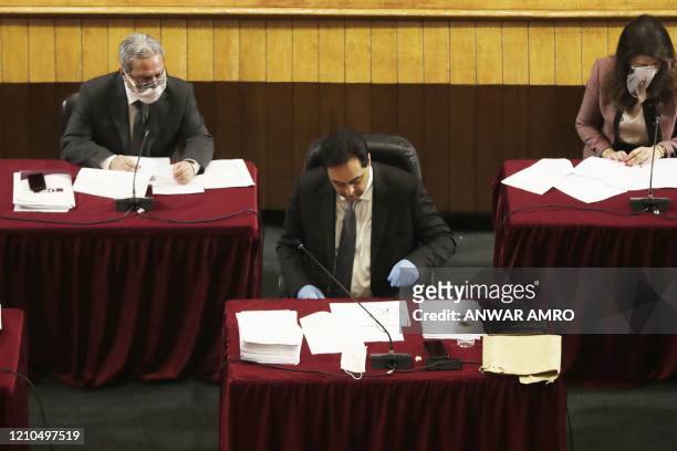 Lebanese Prime Minister Hassan Diab wearing gloves attends a parliament meeting at the Unesco Palace in the capital Beirut, on April 21, 2020. -...