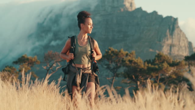 4k video footage of a young woman out on a hike through the mountains
