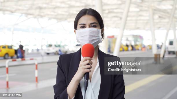 tv reporter wearing a mask - media occupation stock pictures, royalty-free photos & images