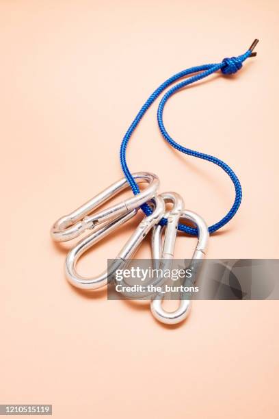 bunch of carabiner with blue rope on brown background - mousqueton photos et images de collection