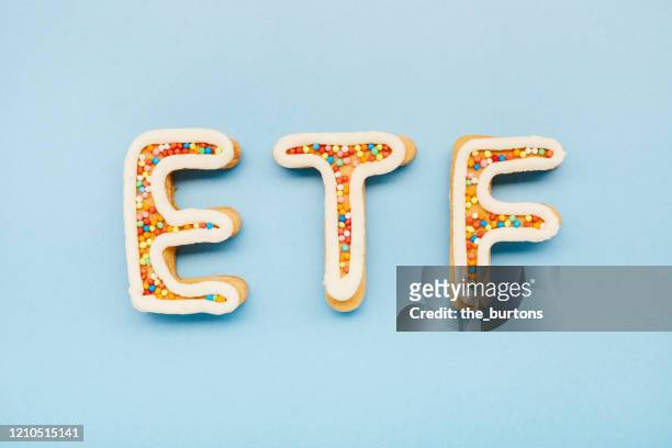 high angle view of etf letters on blue background, symbol of investment in stocks - etf fotografías e imágenes de stock